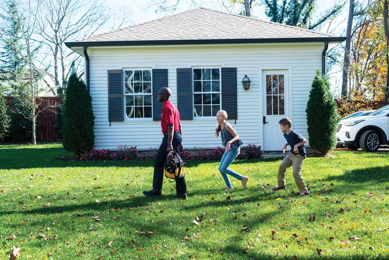 A WeaveAire technician walking up to a Downers Grove home as two children follow along in the front yard